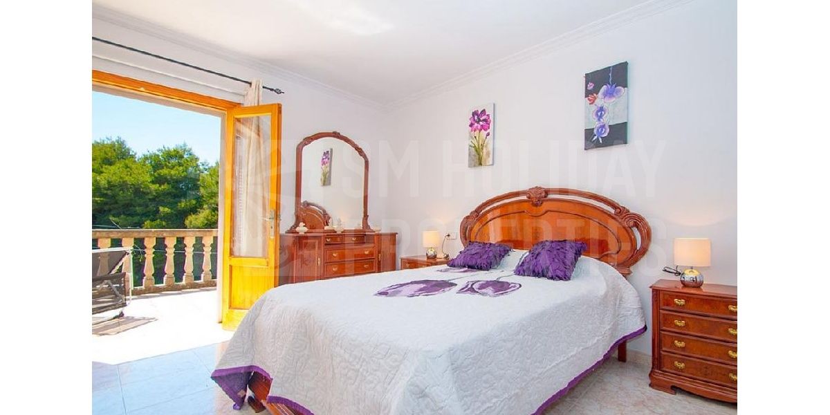 Double purple bedroom with stylish furniture also has a terrace and bathroom..