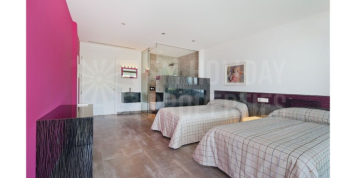 Twin bedroom with en suite and a refined interior design of straight lines.