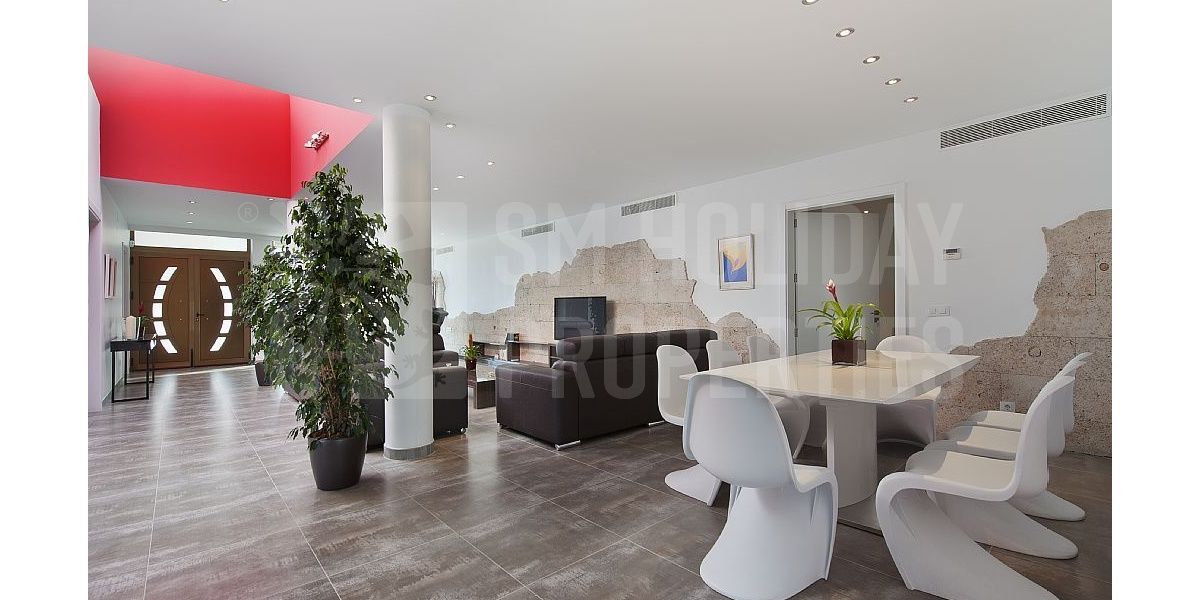 Spacious room with modern design in the large living room with tables Panton.