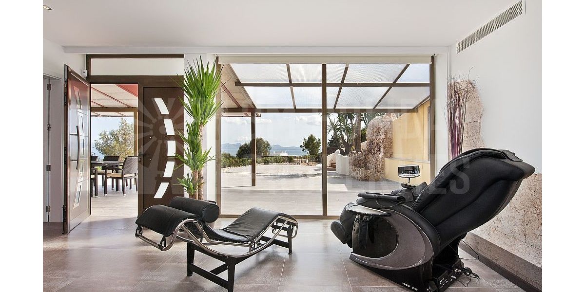 Relaxing massage chair overlooking the sea and Le Corbusier chaise longue.
